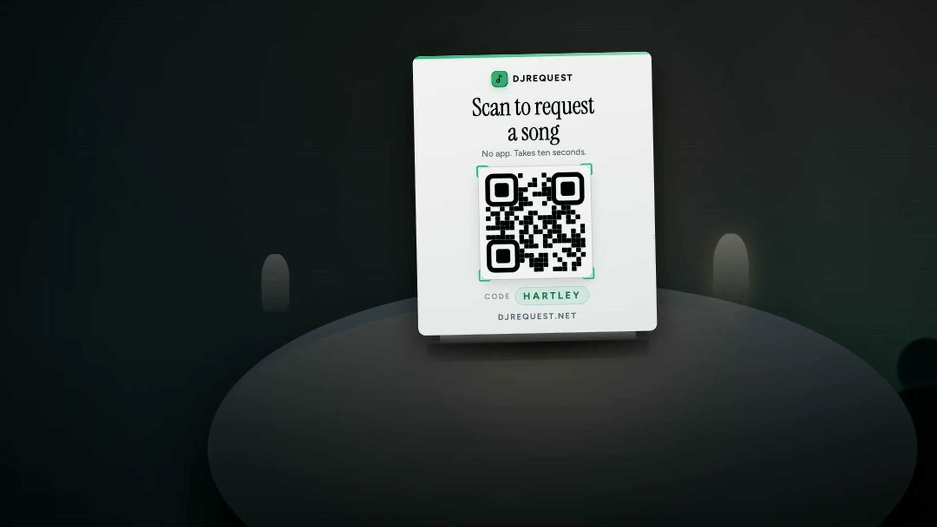DJ Request poster on a table that reads Scan to request a song, with a QR code and the event code HARTLEY.